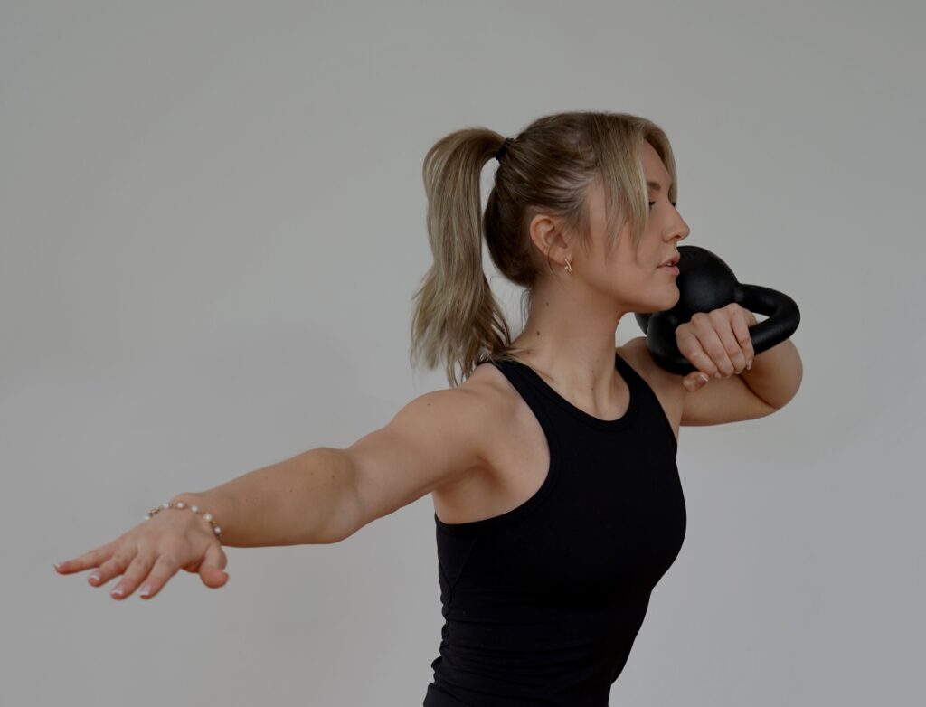 Kettlebell workout woman exercising with kettlebell for strength training and fitness.